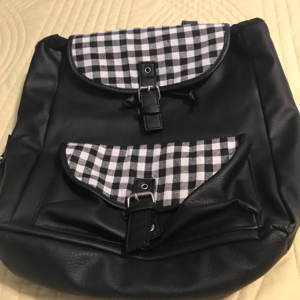 Black backpack with black and white check details